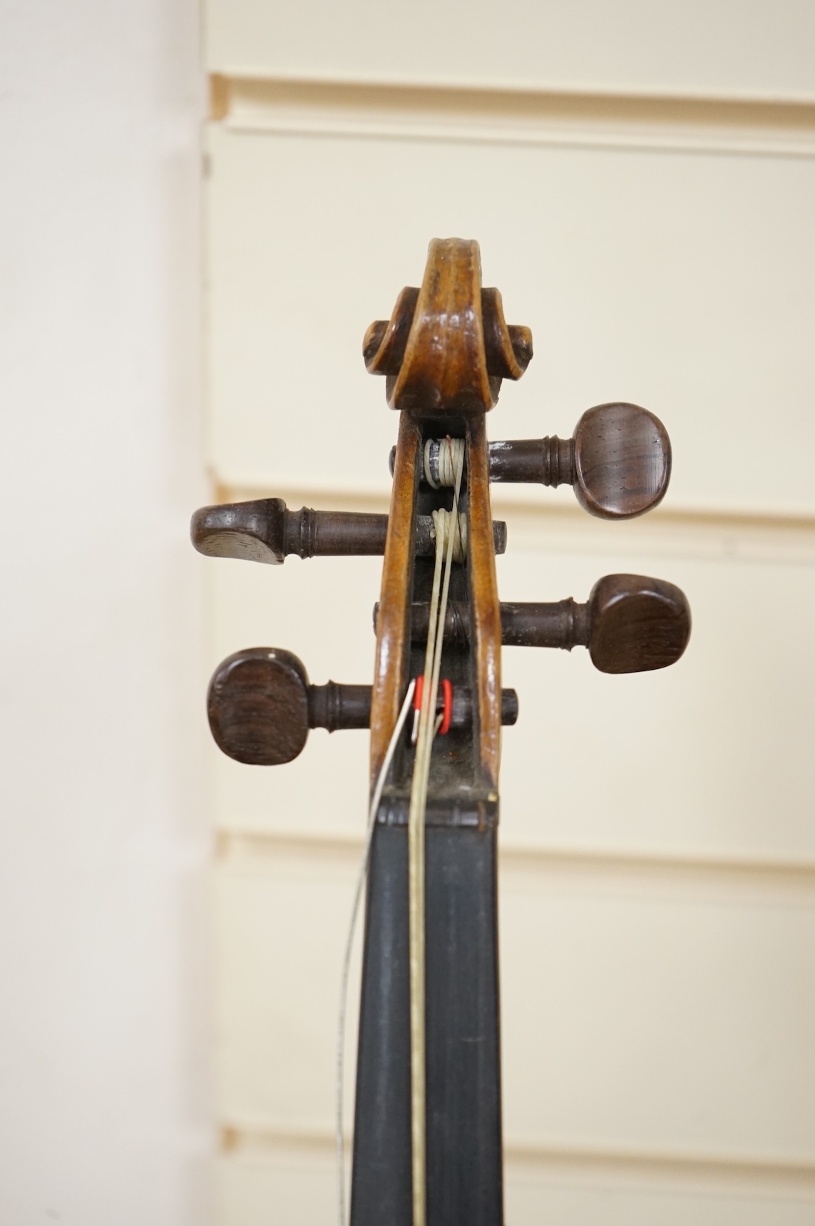 Five cased 20th century violins, including; a German violin, two Czech violins, a three-quarter size violin with a label for Bienfait, and a Romanian quarter size violin, all in cases or the remains of cases.